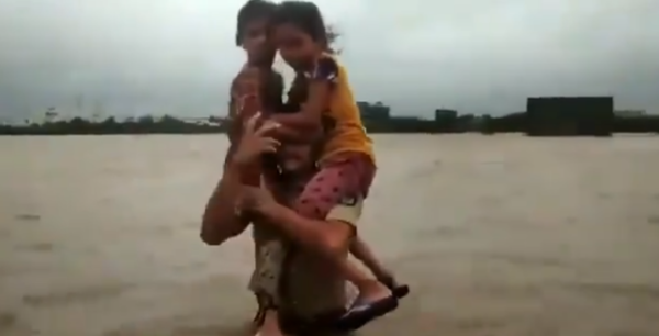Twitter Is Praising The Gujarat Cop Who Carried 2 Girls On His Shoulder In Waist-Deep Floodwater - RVCJ Media